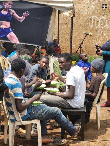 January 20th Action - Young teenage boys sitting near each other and eating out of green bowls