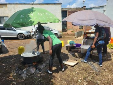 January 20th Action - Large pots of food, being cooked under two umbrellas