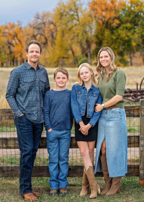 Family portrait outdoors with autumn colors.
