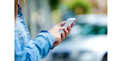 A picture of the woman holding her mobile and checking