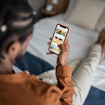 A man is ordering food online using a smartphone.