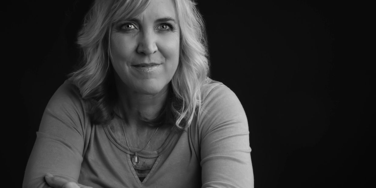 Portrait of a smiling woman in black and white.