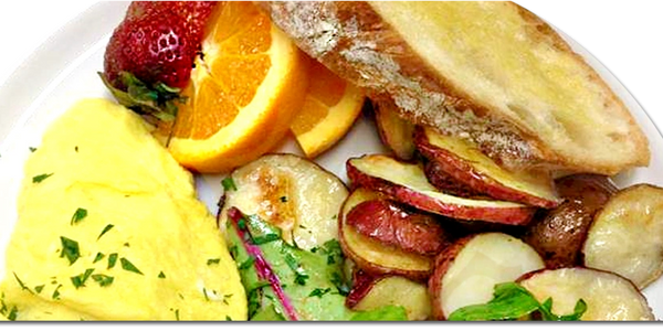 Breakfast plate with omelette, roasted potatoes, orange slices, strawberry, and toasted bread.