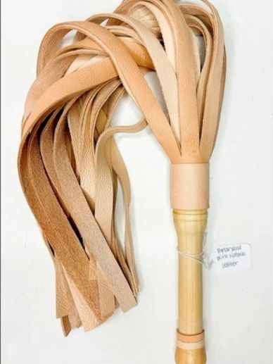 A natural leather flogger with multiple tan leather tails and a wooden handle.