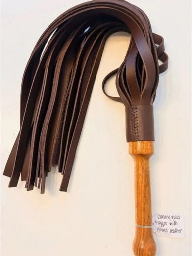 Handcrafted flogger with wooden handle and leather tails.