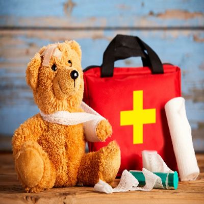 first aid photo of first aid kit and bear with bandages