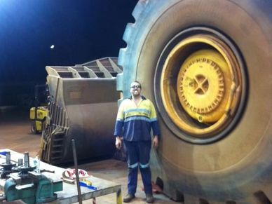 Person standing next to mining equipment