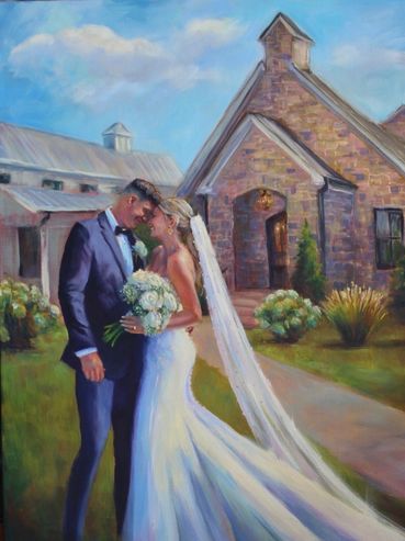 A bride and groom share a tender moment outside a rustic church.