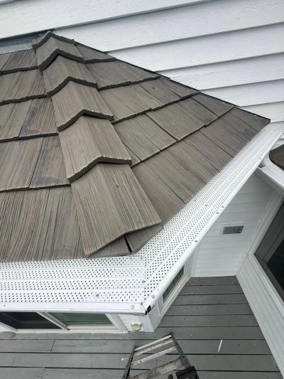 White micro-mesh gutter guards installed on a cedar shake roof in Crystal Lake, IL