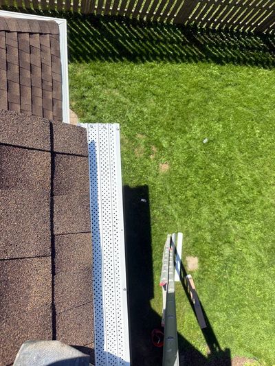 Micro-mesh gutter guard installed on a home's gutter, viewed from the roof edge