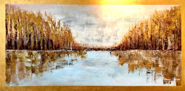 Autumn trees reflected on calm water under a cloudy sky.