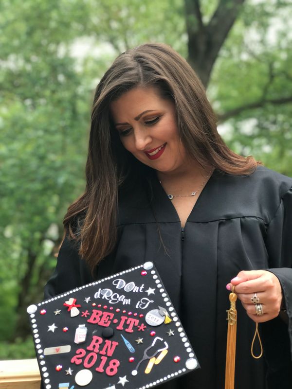 Photo of designer in graduation gown holding graduation cap the day she graduated nursing school.