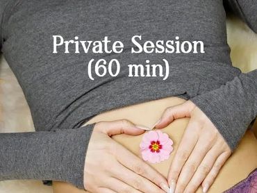 woman with hands on her belly and a flower between her hands