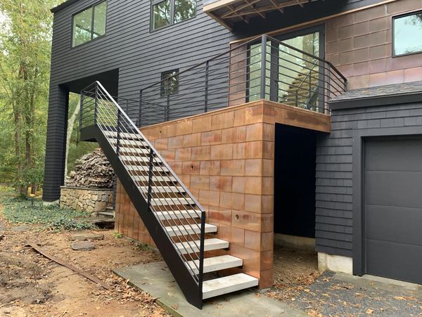 Large white modern waterfront home.