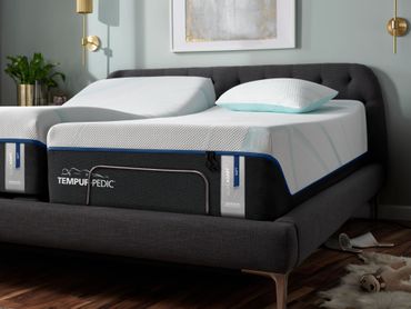 Tempur-Pedic Luxe Adapt Soft Split King Adjustable Mattress Set in an upholstered bed frame.