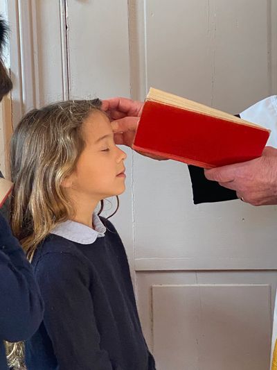 Child Receiving the Sign of the Cross