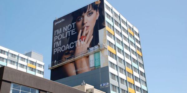 Large billboard advertisement for Proactiv featuring Katy Perry on a tall building.
