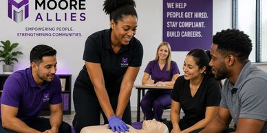 A group learning CPR with a Moore Allies instructor in a training session.