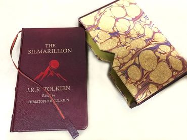 Luxury clamshell case with decorative marbled finish and fitted book.