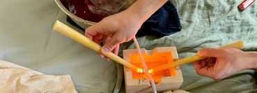 Home birth family doing a cord burning ceremony with candles to sever the umbilical cord