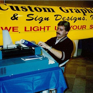 Marvin Thole circa 1990 at a Home and Patio show with one of the first computerized vinyl plotters