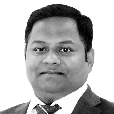 Professional man in a blue suit and tie with a neutral expression.