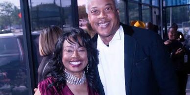 Smiling couple posing together at an event.