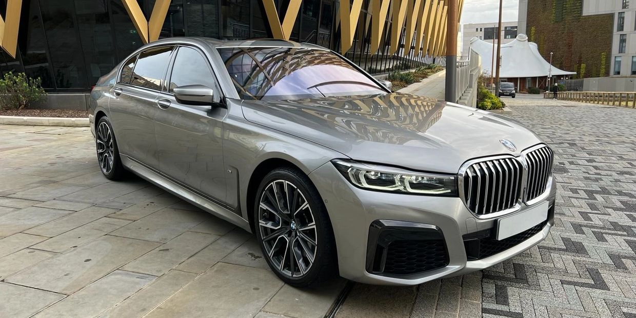 Silver BMW sedan parked in an urban setting.
