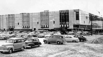 1950's cars and buildings in the back