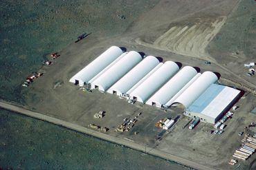 Aerial view of row of white arched sheds