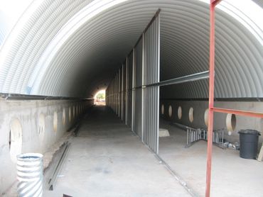 View down a long arched metal corridor