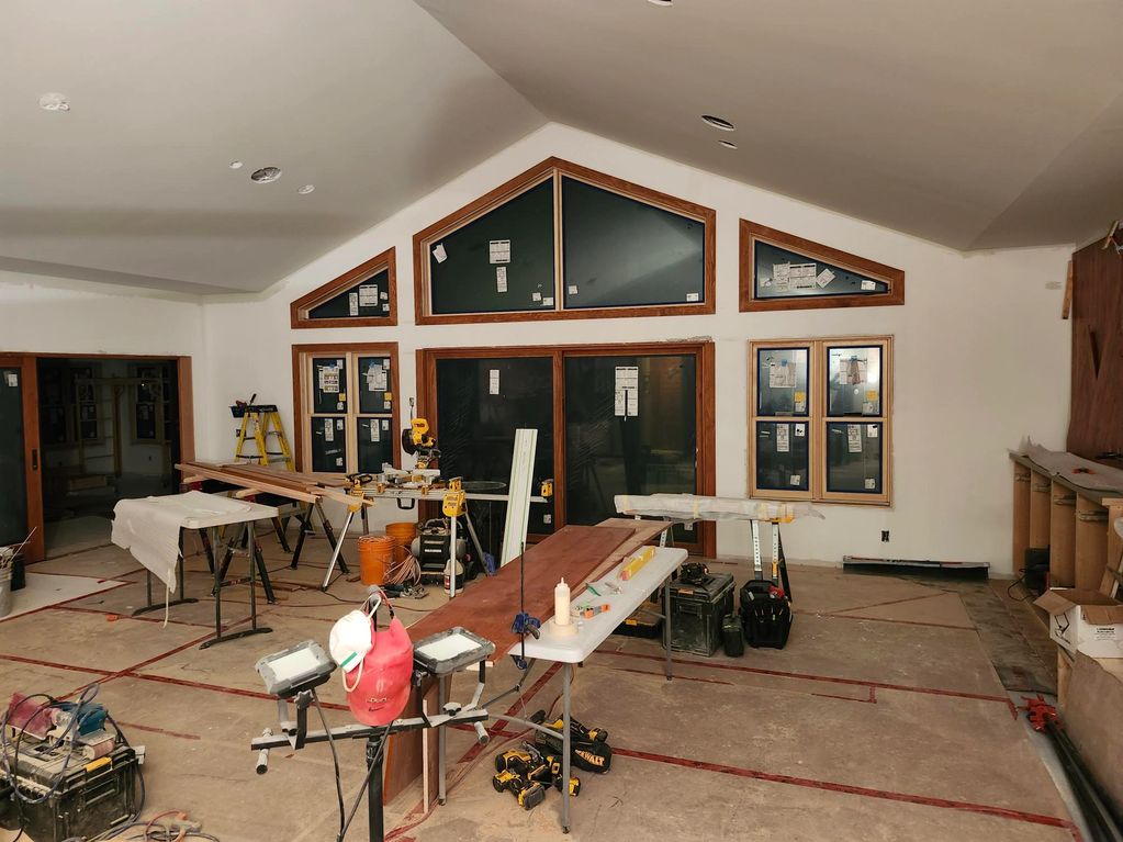 Interior of a room under construction with tools and materials scattered around.