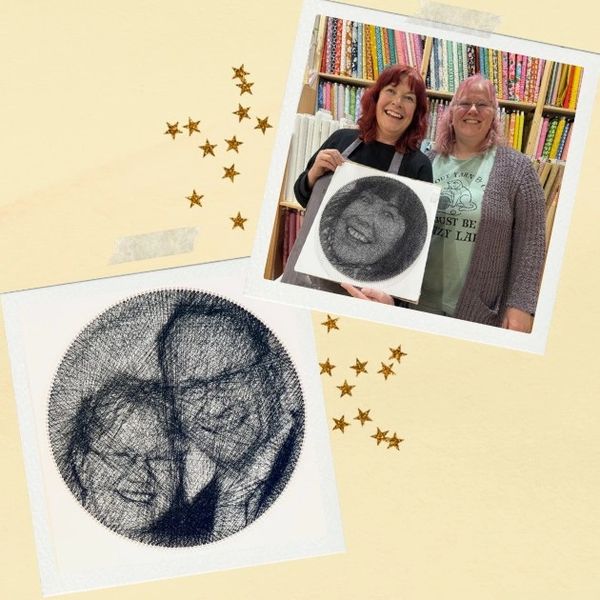 Two women proudly display unique string art portraits of themselves and a couple.