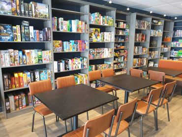 Tables and chairs in front of our board game library