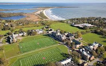 A coastal campus with sports fields near the ocean.