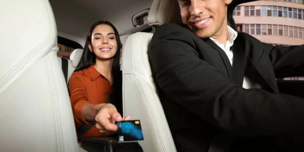 a business woman making a paymnet for a limo transfer at houston airport