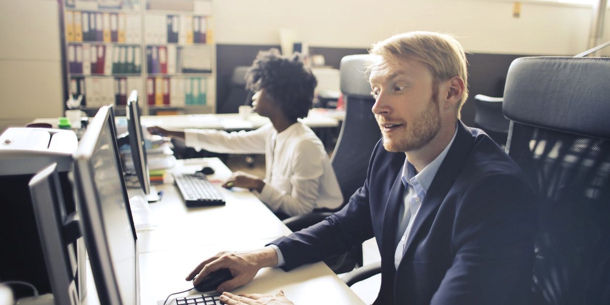 persons in a control room monitoring processes