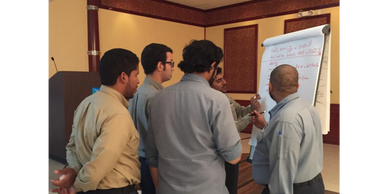 Group of men in training class working on group assignments to understand equipment safety.