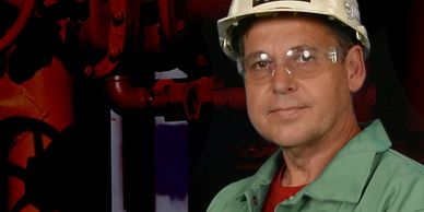 John puskar photo with hardhat and fire resistant clothing at industrial site.