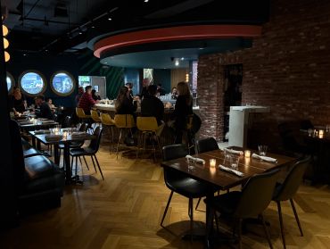 Cozy, dimly lit restaurant interior with patrons.