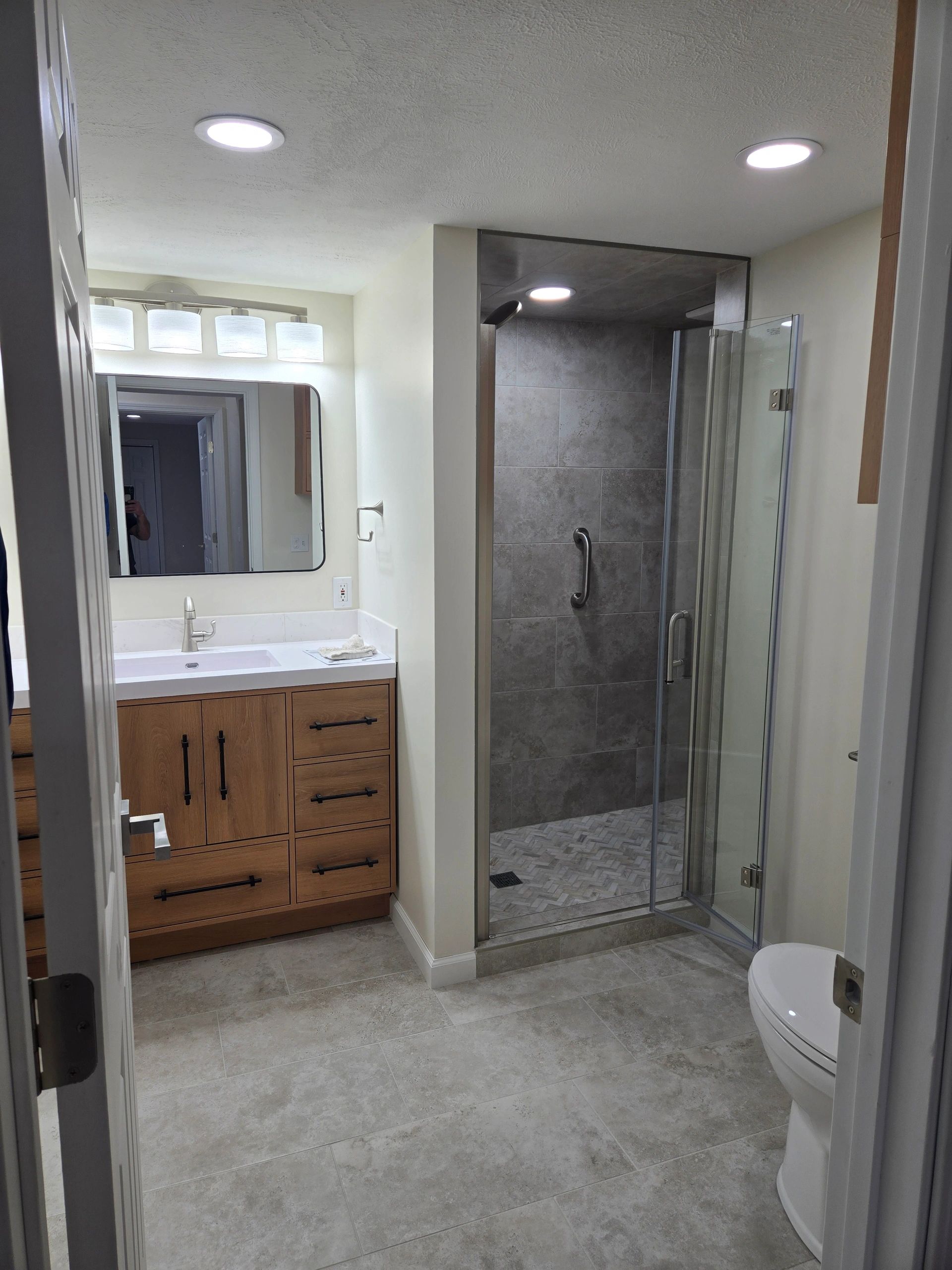 Modern bathroom with custom tile shower.