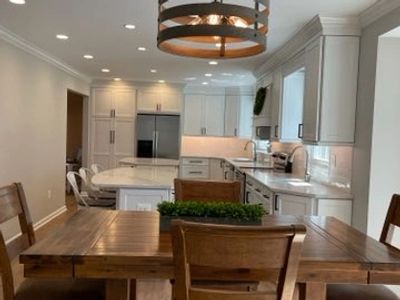 Remodeled kitchen with a wood dining room table