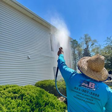 Soft washing an apartment complex building.