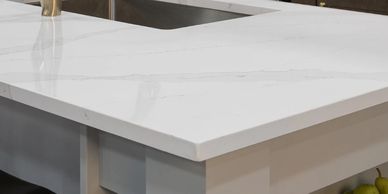 Close-up of a white marble kitchen countertop with subtle gray veining.