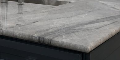 Close-up of a polished gray marble countertop with subtle veining.
