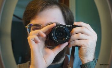 Man standing in front of mirror with camera