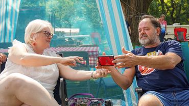 Man holding phone out to woman