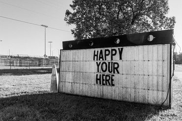 Advert sign that says "Happy your here"