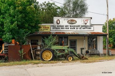 Old tractor in front of mechanic shop