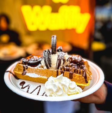 Waffly: freshly baked sweet waffle with chocolate sauce and selection of toppings